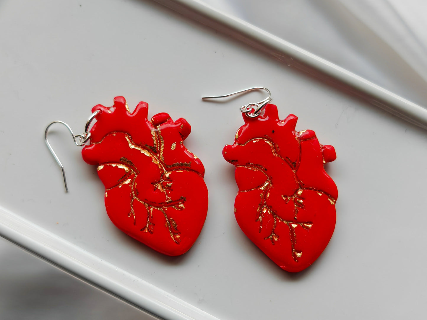 Red and gold anatomical heart earrings