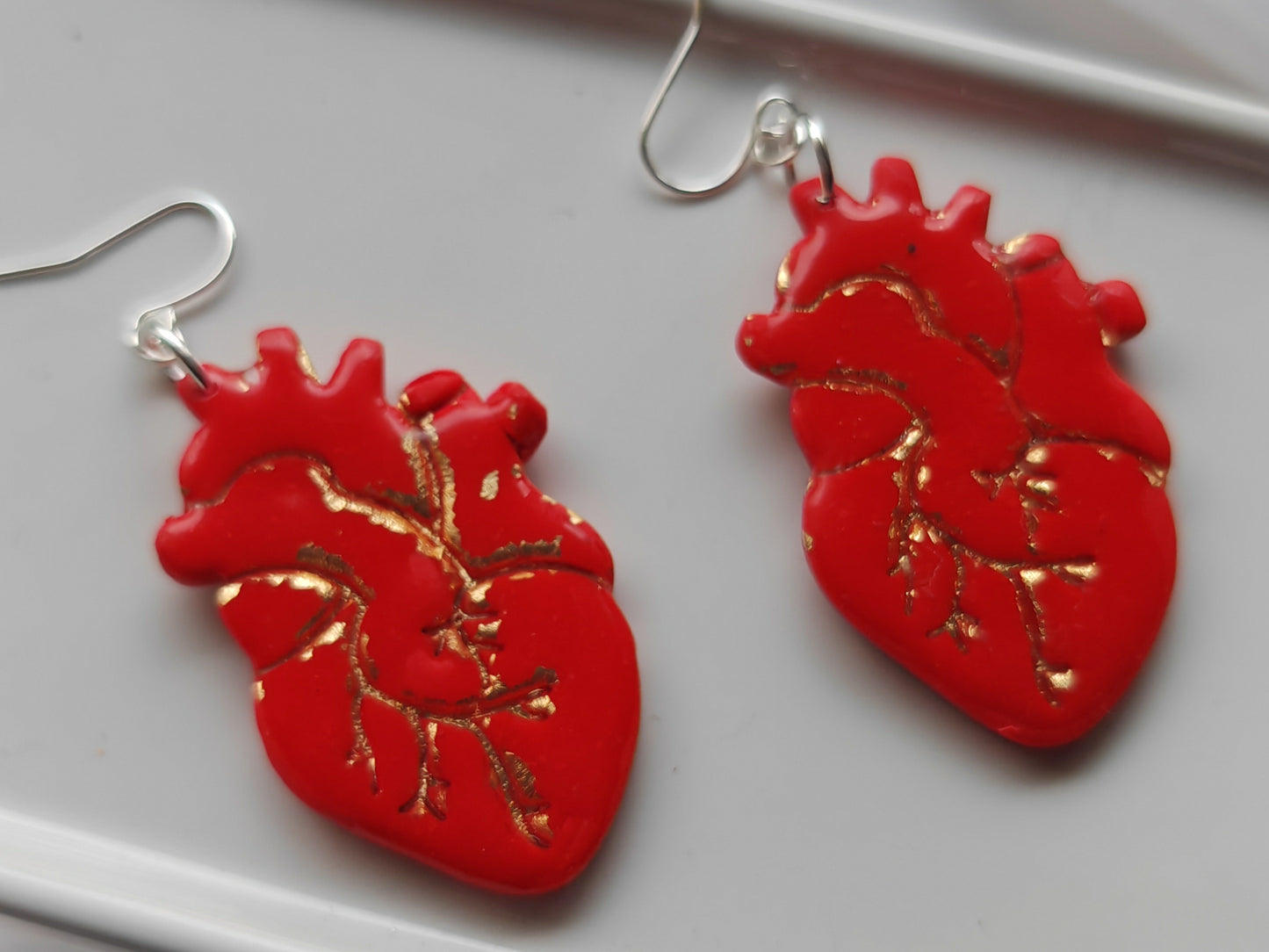 Red and gold anatomical heart earrings