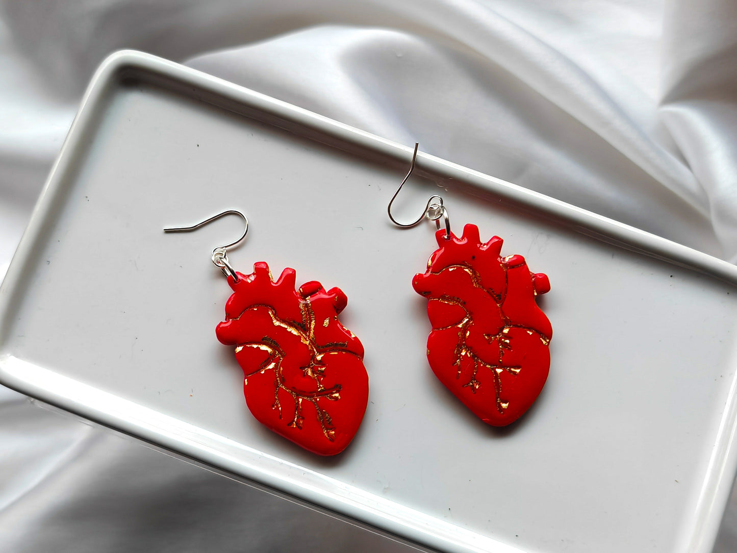Red and gold anatomical heart earrings