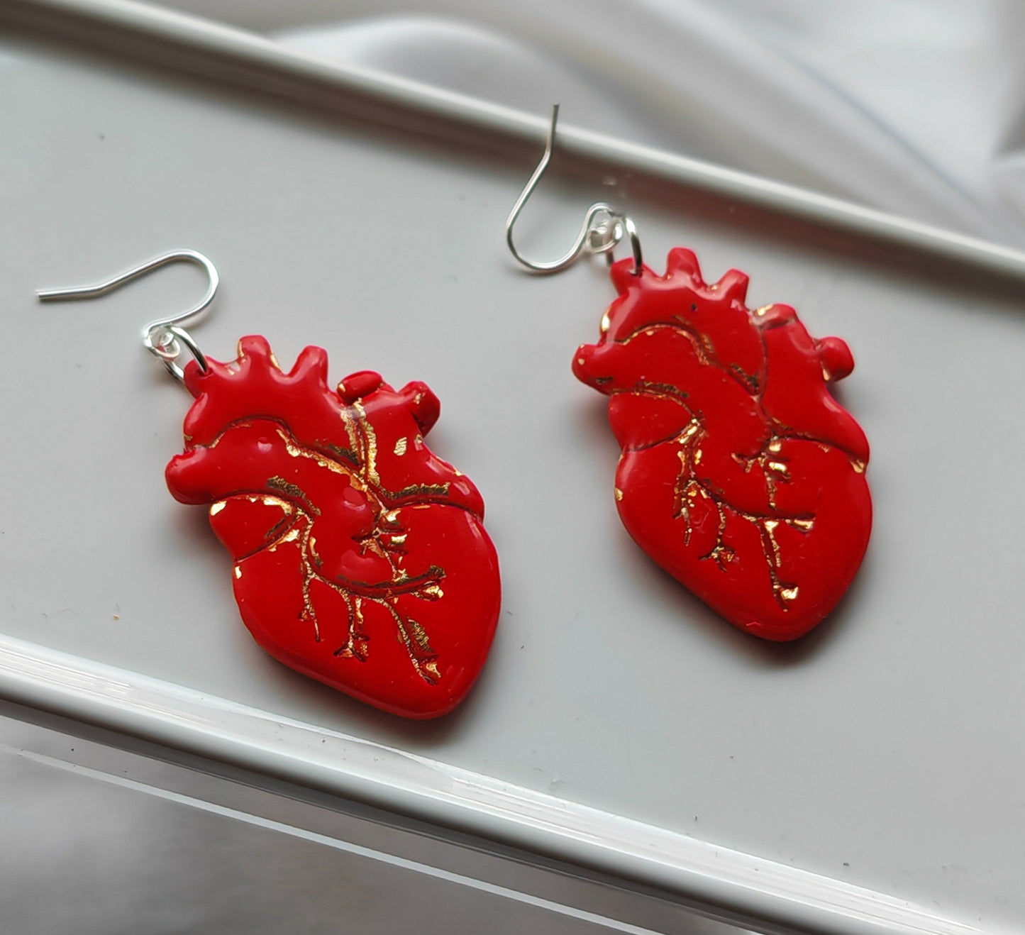 Red and gold anatomical heart earrings