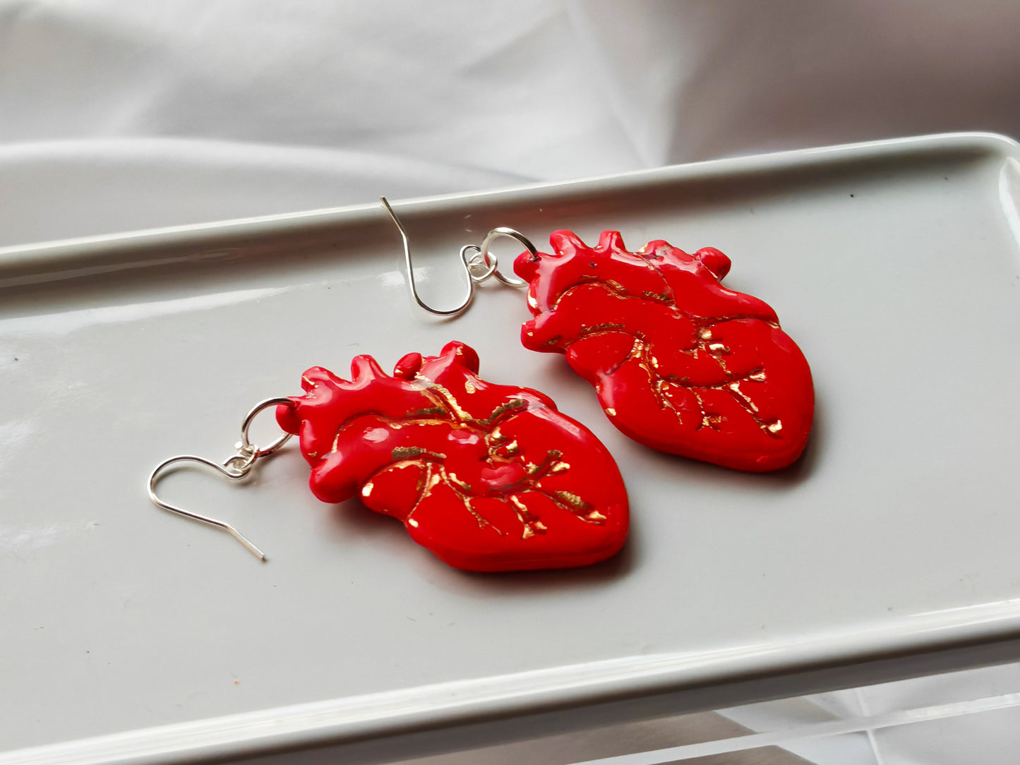 Red and gold anatomical heart earrings