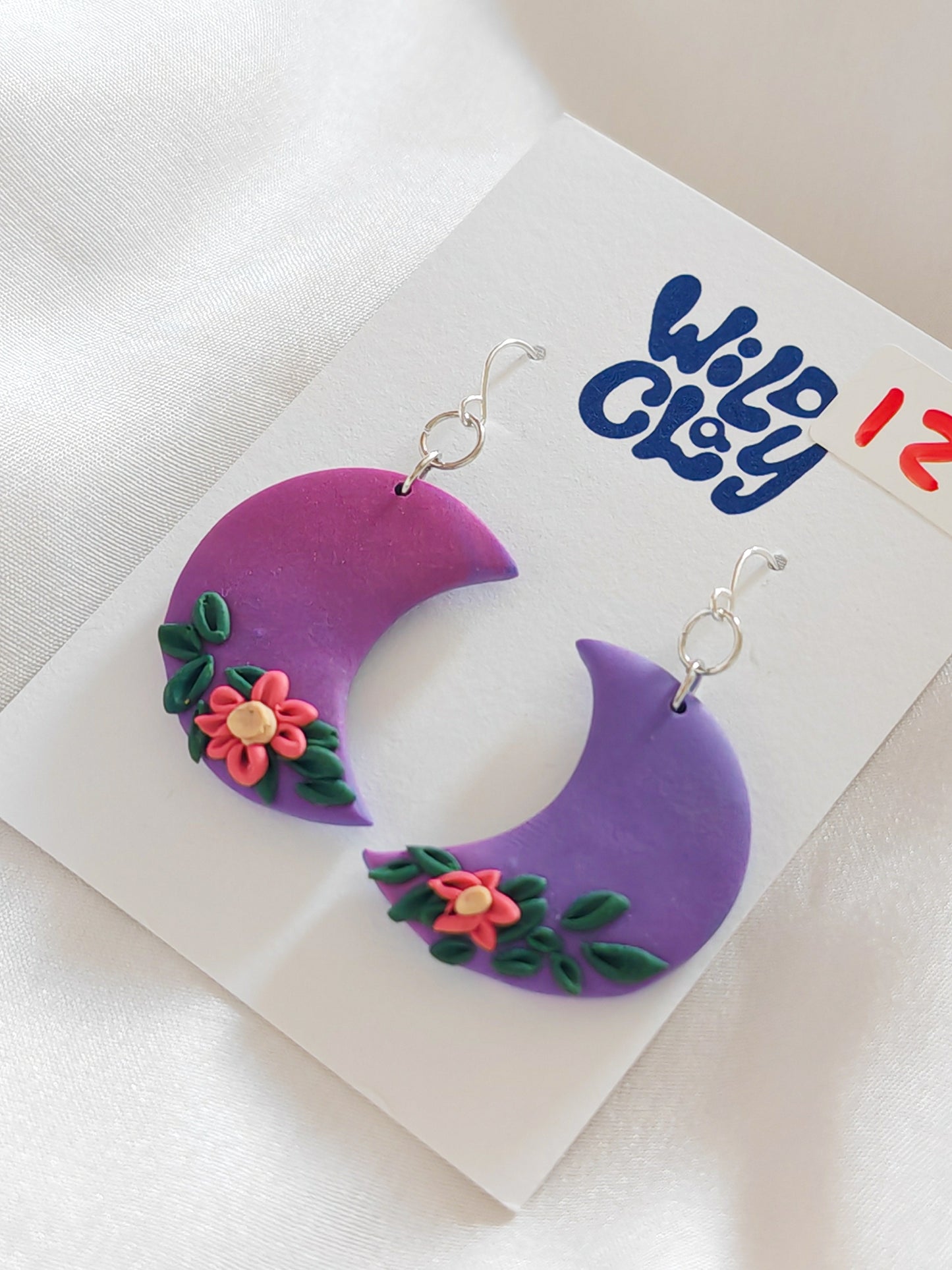 Purple moon earrings with floral detail