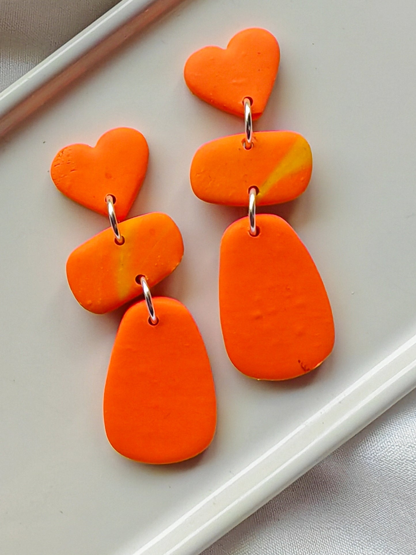 Orange heart dangle earrings