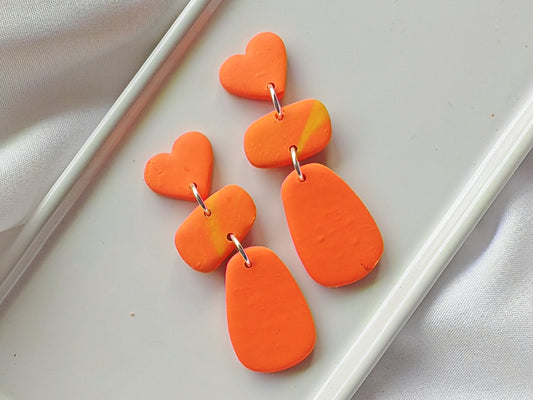 Orange heart dangle earrings