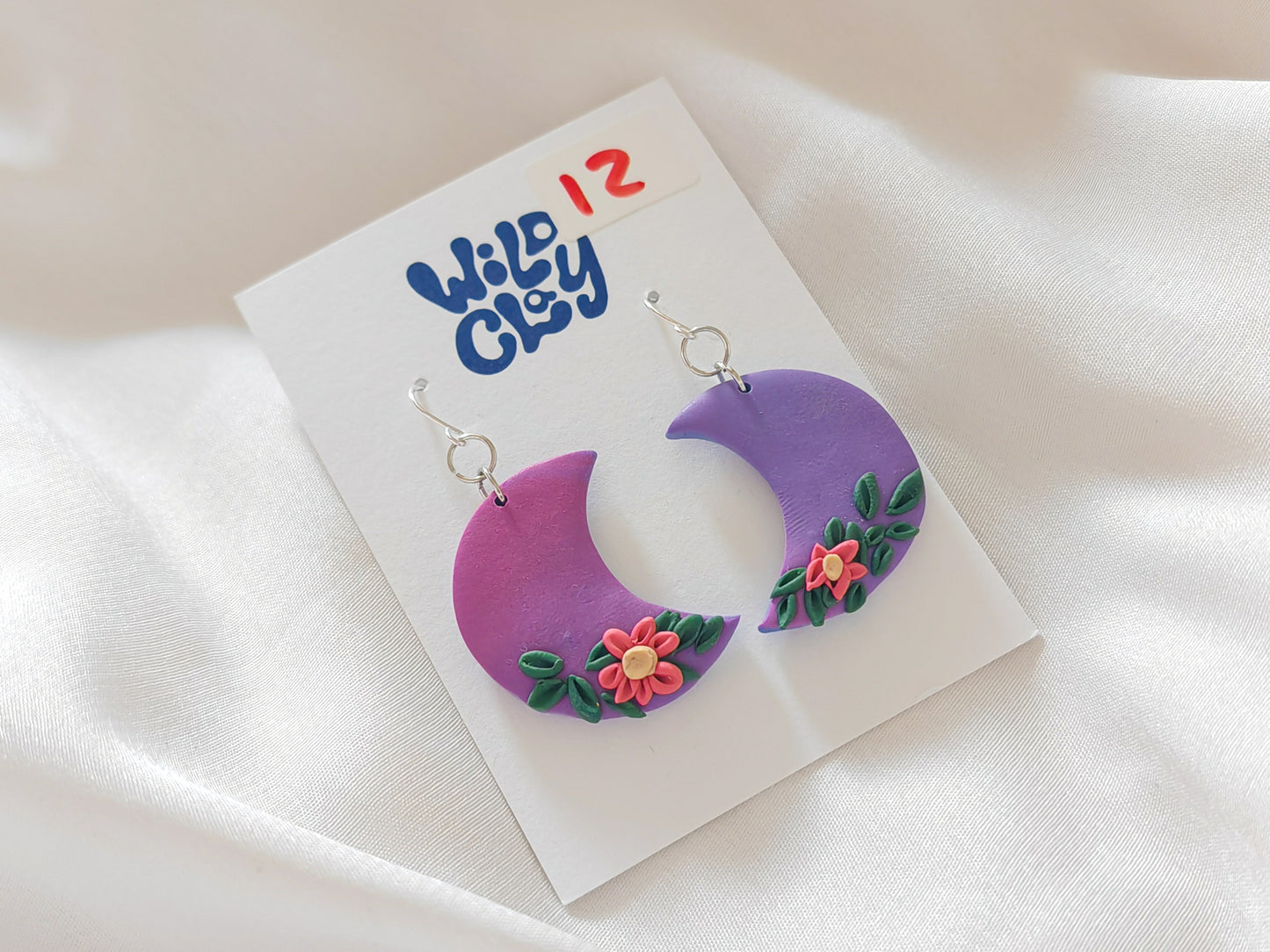 Purple moon earrings with floral detail